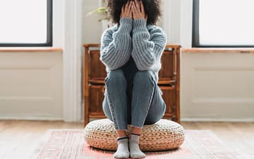 faceless unhappy woman covering face